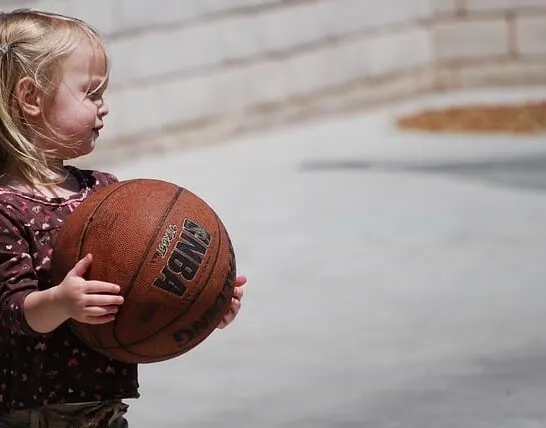 toddler holding a basketball