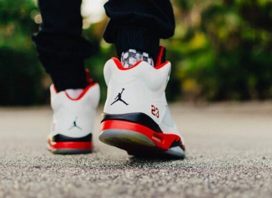 Person walking in Jordan 8 basketball shoes.