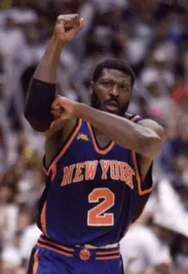 Larry Johnson making the his patent L with his arms in a knicks unifrom